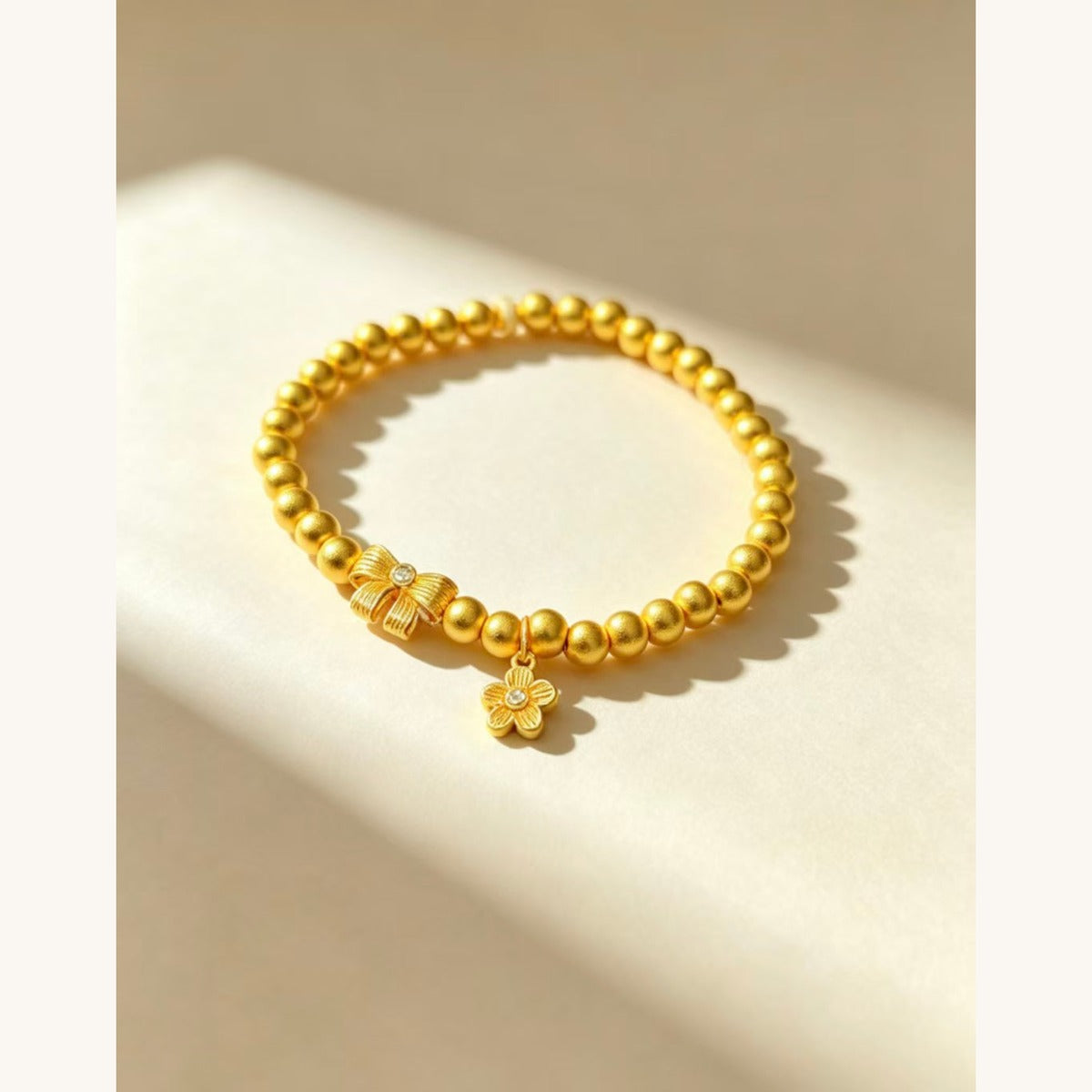 Gold Bead Bracelet with Bow & Flower Charm